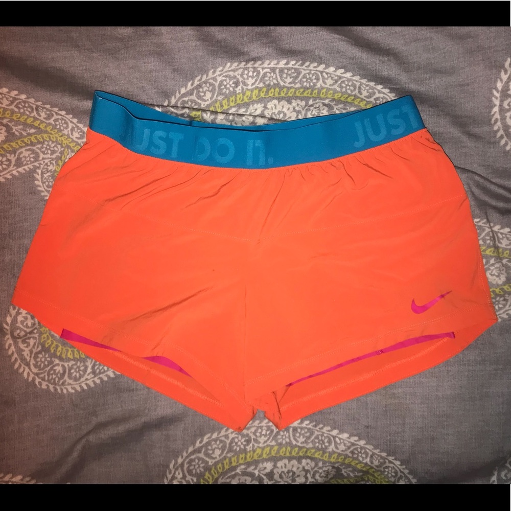 Orange Nike shorts size M with compression under